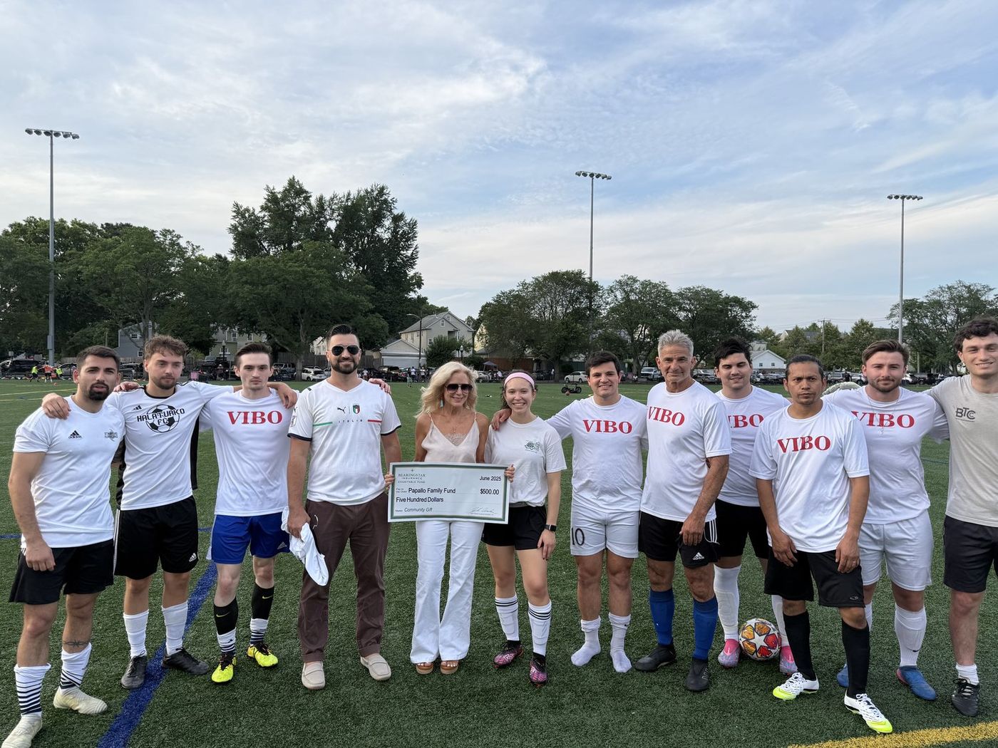 Christopher Papallo with sponsor Sally Schneider presenting a community gift to the Stamford Italian Soccer League alongside U.S. Vibo in June 2025