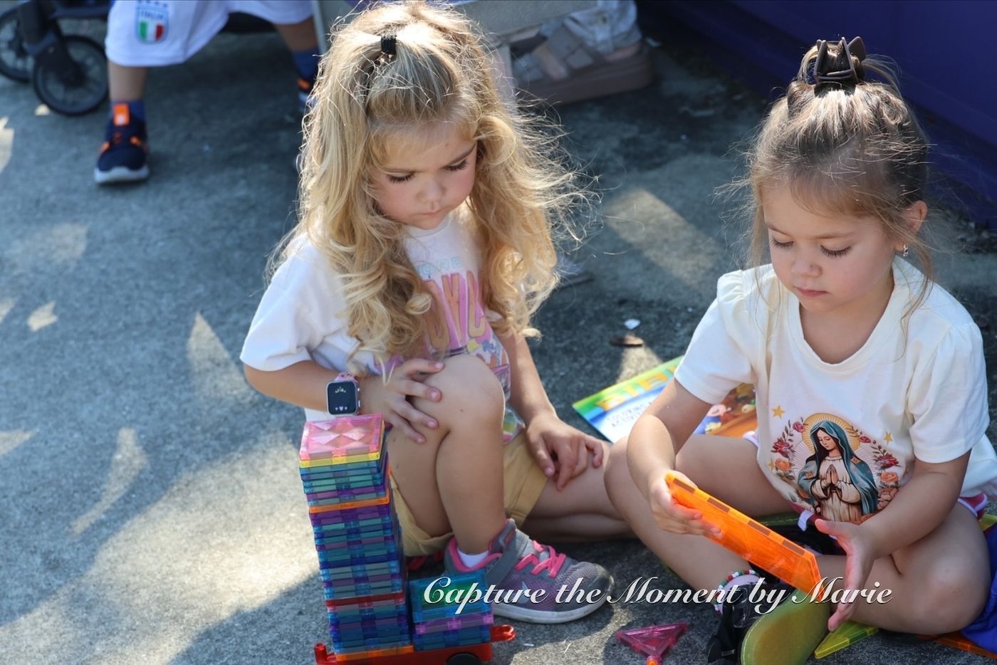 Children playing with building tiles at the family activity area during the 2025 Finals Celebration.