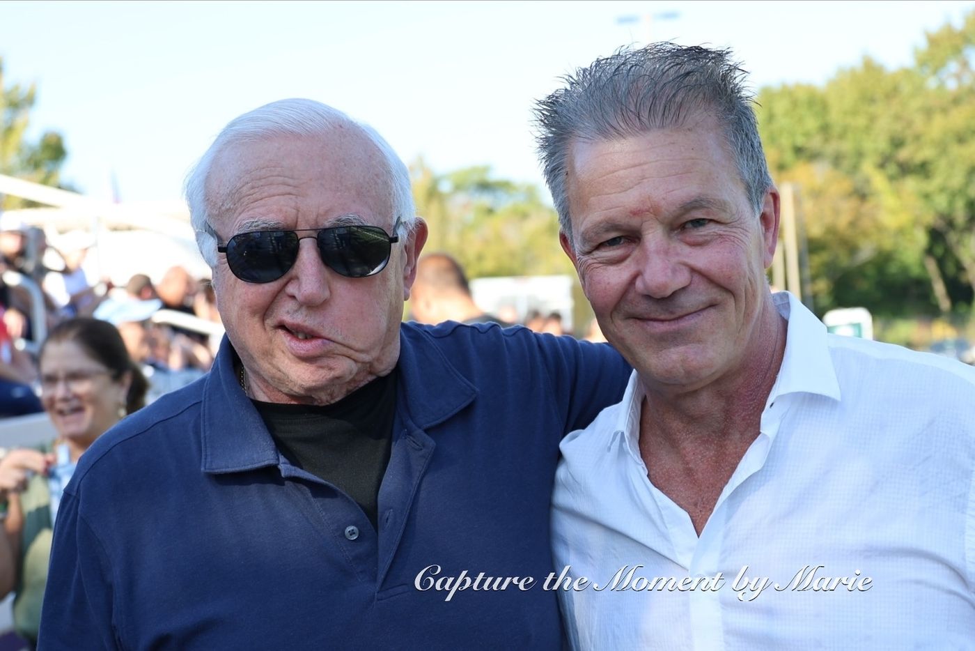 Longtime supporters together on the sideline at the 2025 Finals Celebration.
