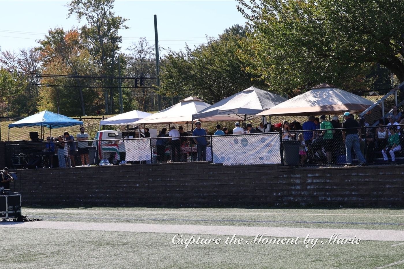 Food and community partner tents lining the field at the 2025 Finals Celebration.