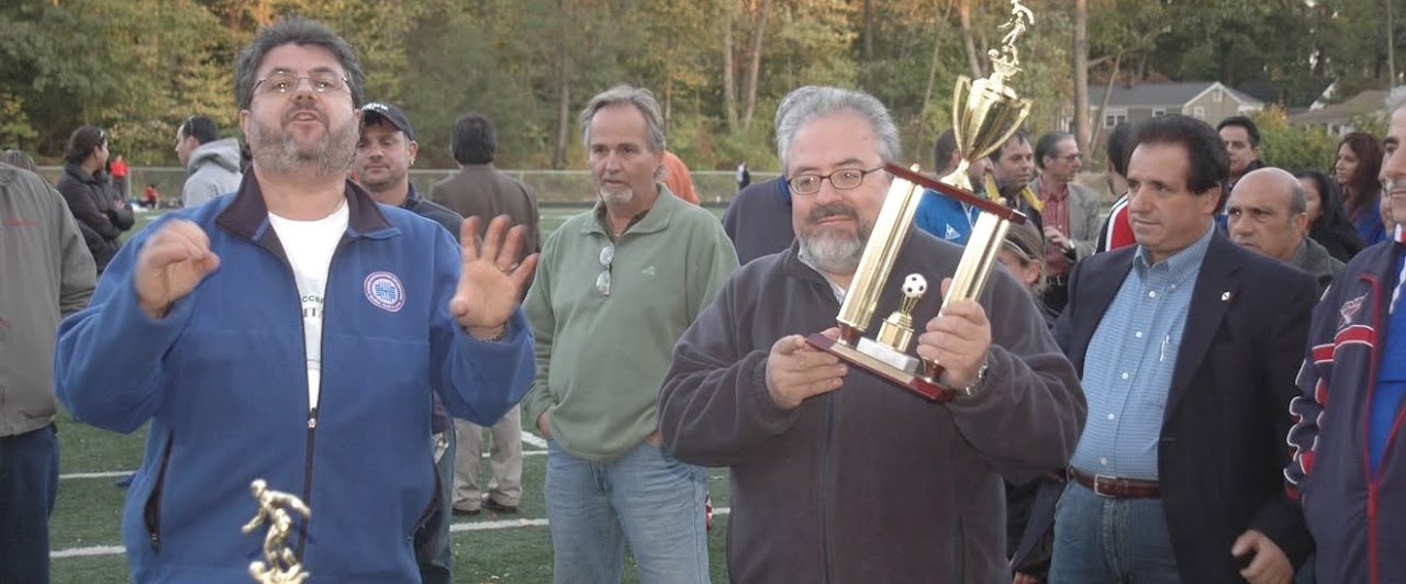 Nino Antonelli presenting the championship trophy at a Stamford Italian Soccer League Finals