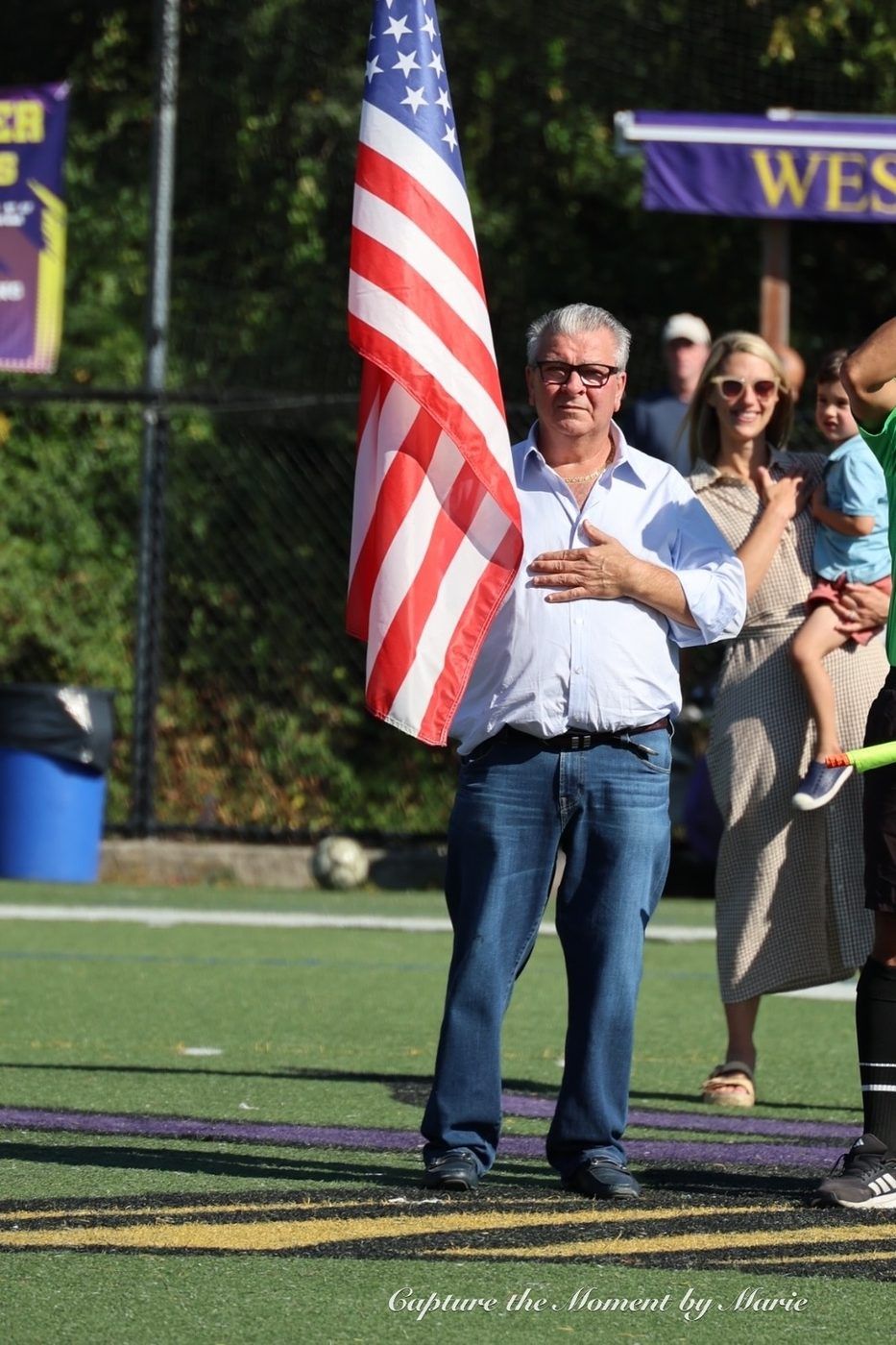 George Papallo holding the American flag during the national anthem at the Stamford Italian Soccer League 30th Anniversary Finals Celebration